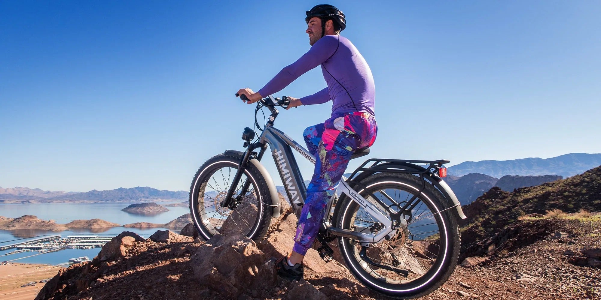 Person riding a electric bike on a mountain with a scenic background