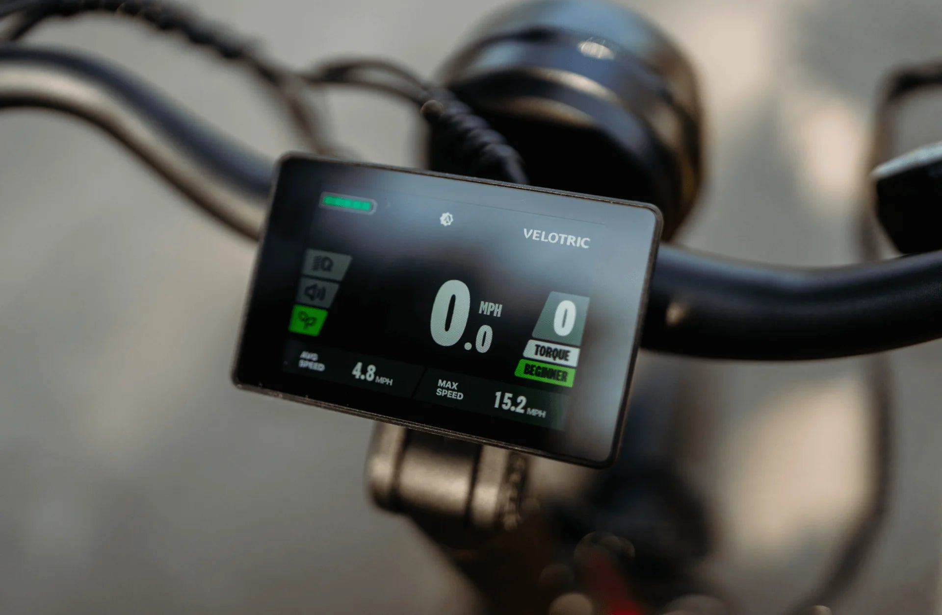 Bicycle speedometer with Velodric branding on a blurred background