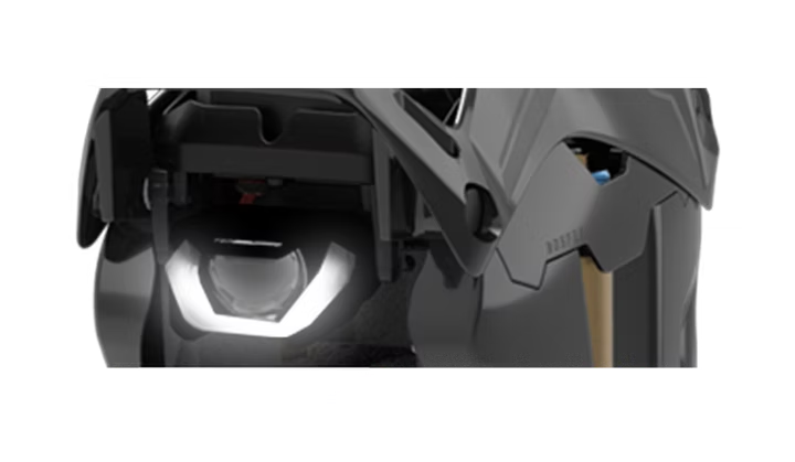 Close-up of a motorcycle headlight with a white background