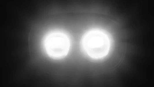 Two bright headlights on a dark background
