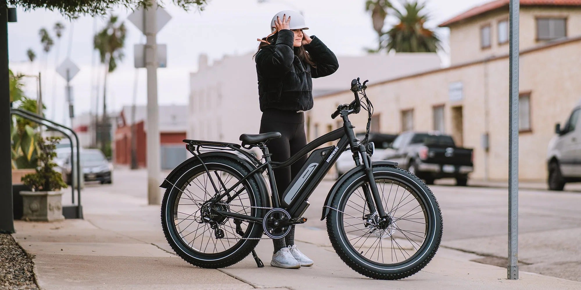 Person with an electric bike on a city street